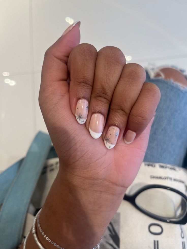 Chic French Tip Nail Design with Delicate Floral Accents on Nude Base