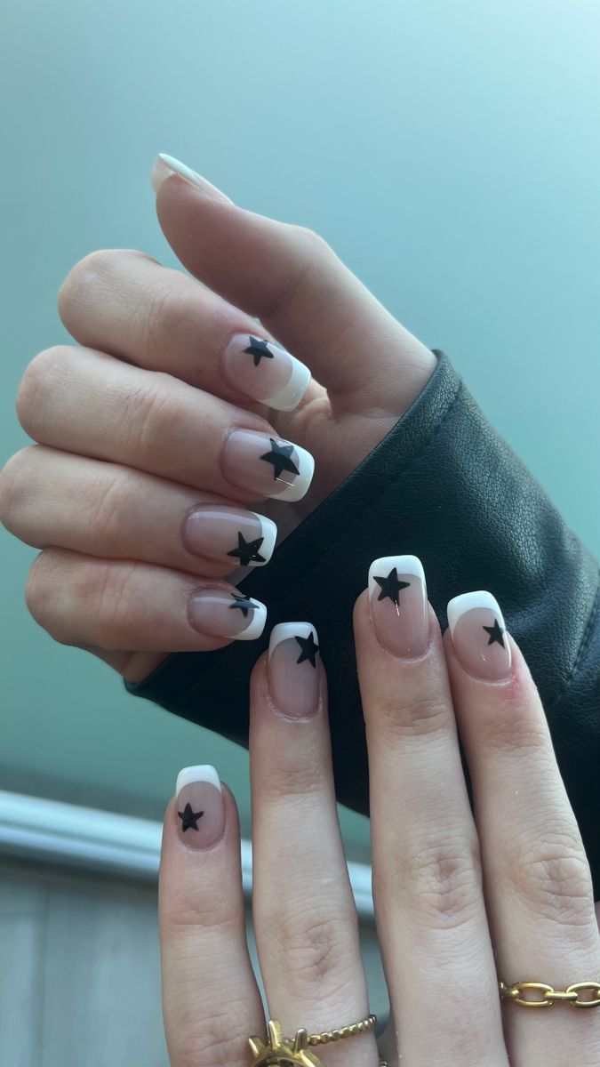 Elegant French Tip Nails with Black Star Motifs for a Playful Touch.