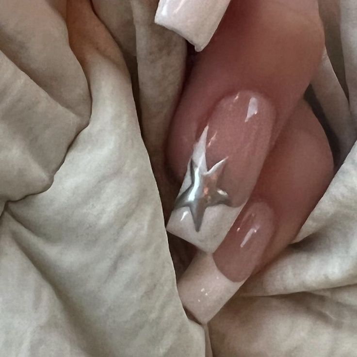 Captivating Elegant Nail Design with Nude Base and Glamorous Silver Star Accent.