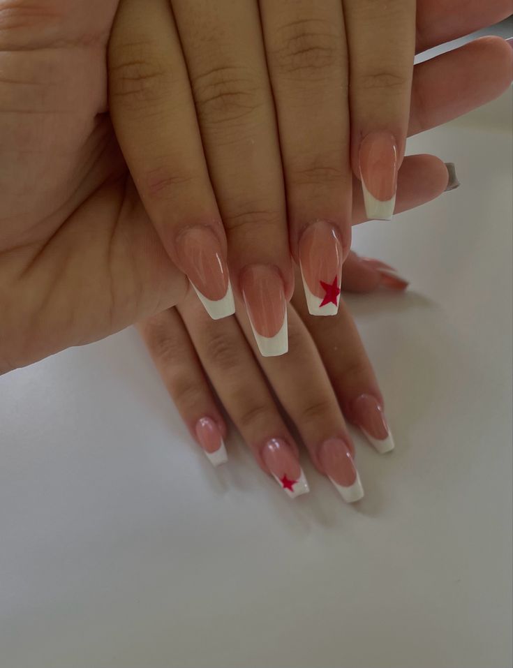 Elegant French Tip Acrylic Nails with Bold Red Stars: A Playful Twist for Any Occasion.