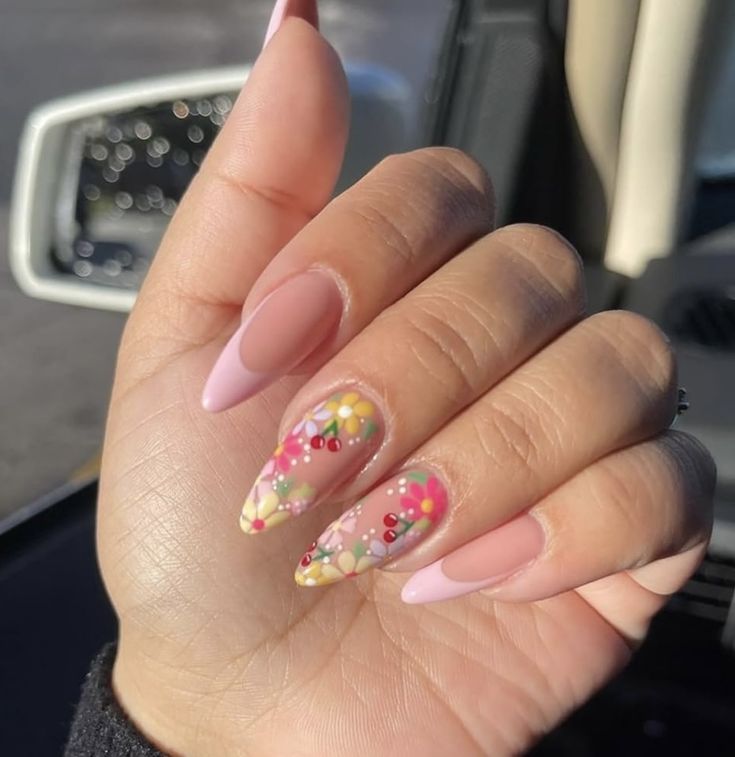 Charming Almond-Shaped Nails with Soft Pink and Floral Accents for a Playful Spring Aesthetic.