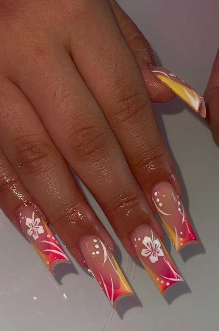 Vibrant Sunset-Inspired Nail Design with Pink and Yellow Hues Enhanced by Elegant White Florals