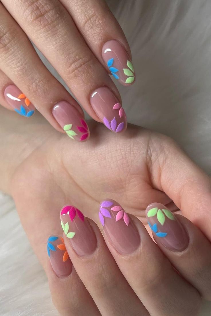 Vibrant Floral-Inspired Nail Design with Colorful Leaf Patterns on a Natural Pink Base.