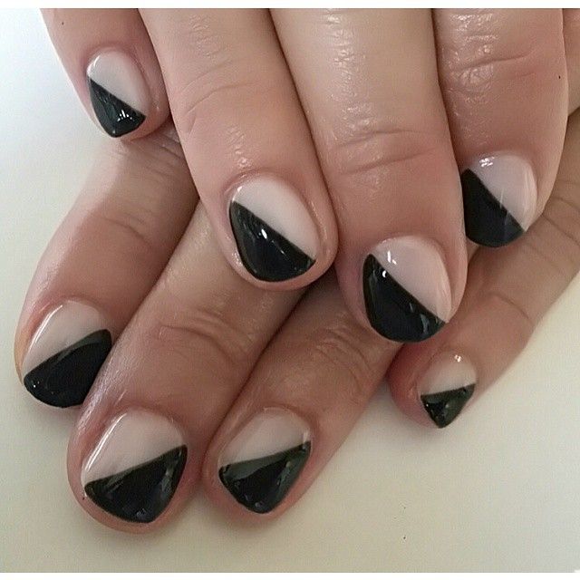 Modern Geometric French Manicure with Sleek Triangular Design in Glossy Black and Nude.