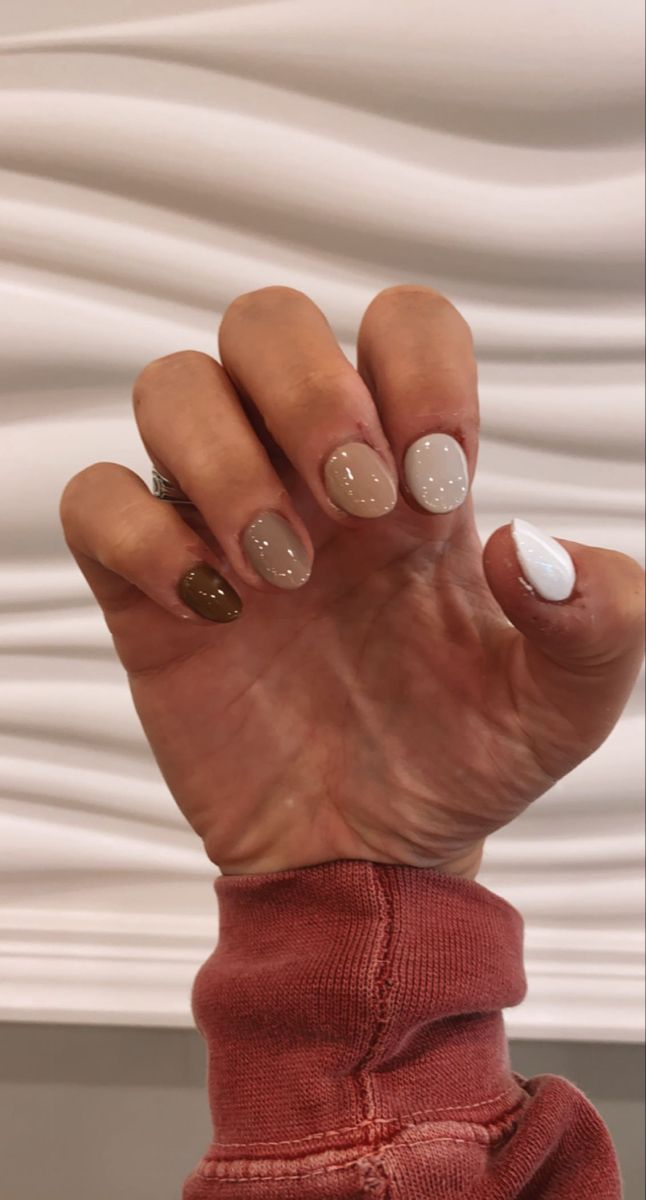 Chic Nail Design: Elegant Neutral Tones with Olive Green Accent.