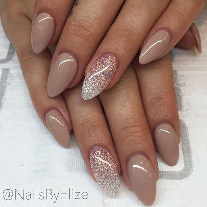 Chic Almond-Shaped Nail Design with Soft Nude Base and Glittery Accent.