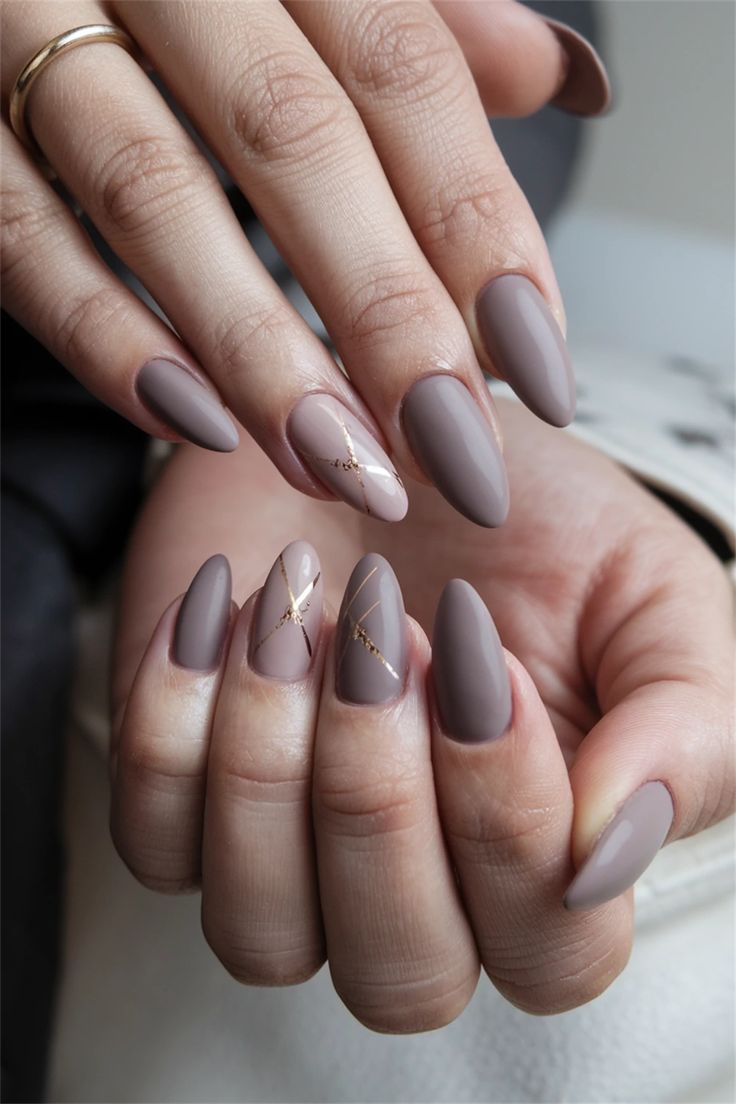 Sophisticated Muted Taupe Nail Design with Glossy and Matte Finishes and Glamorous Gold Accents.