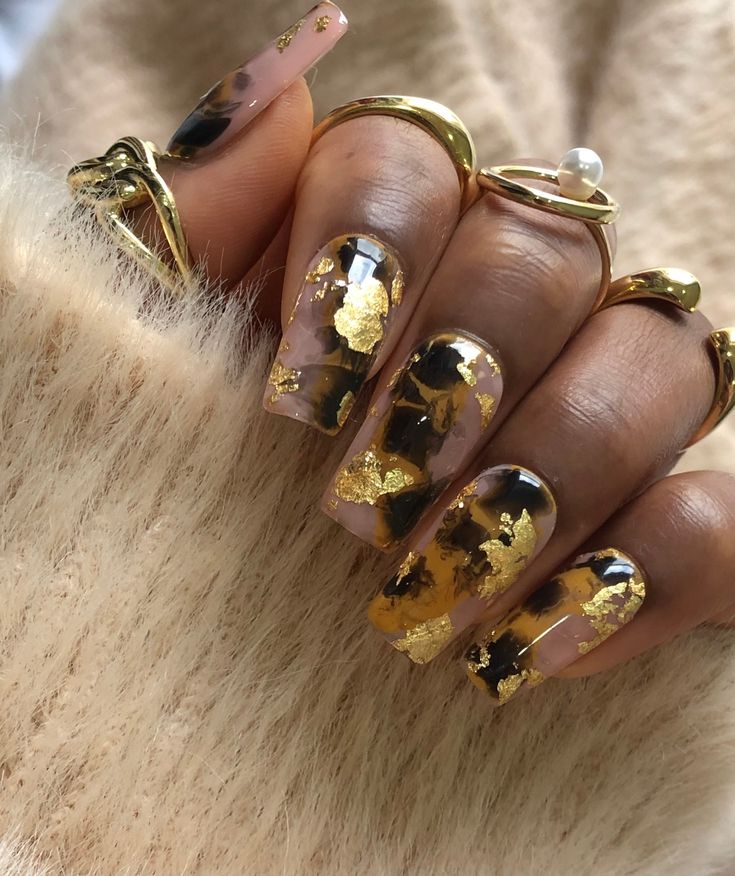 Chic and Sophisticated Nail Design: Clear and Nude Polish with Gold Leaf Accents