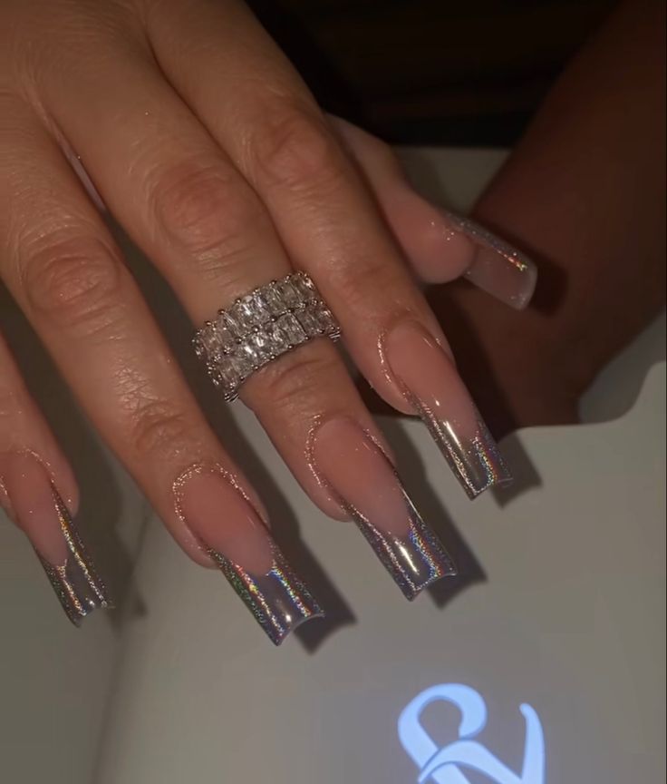 Sophisticated Chrome-Finished Nail Design with Nude Base and Glamorous Ring Accent.