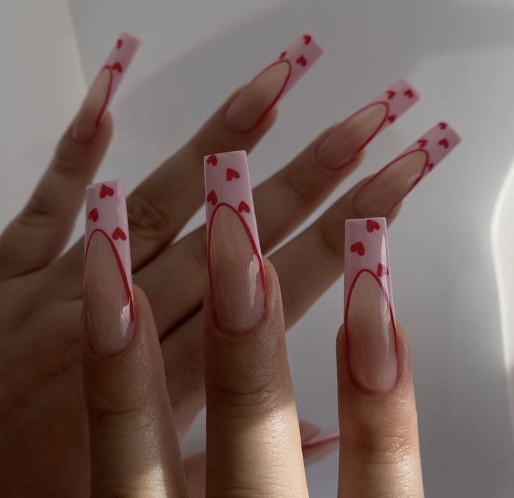 Chic Long Nails with Translucent Pink Base and Playful Red Heart Design