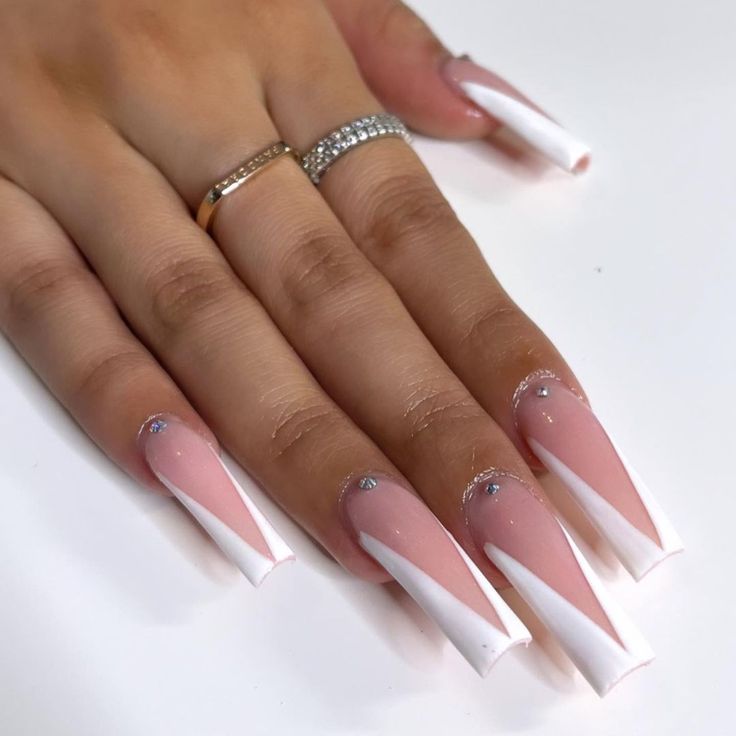 Chic Glossy Pink Nails with White Geometric Tips and Rhinestone Accents.