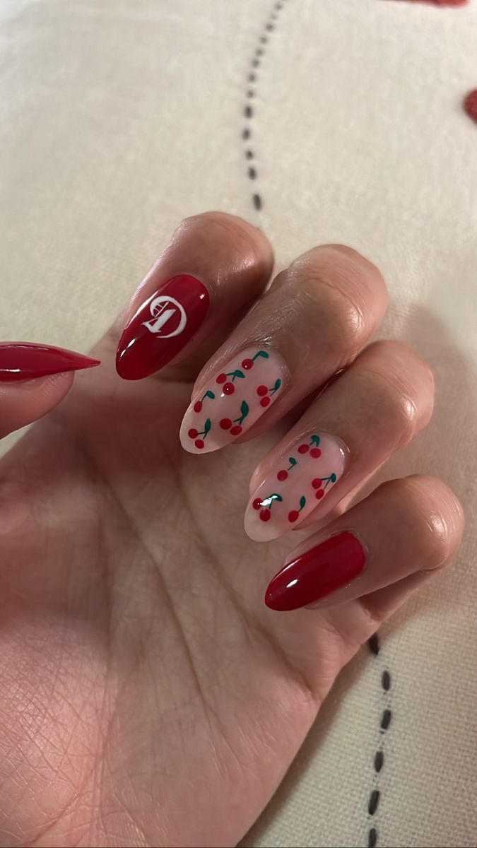 Festive Nail Design: Glossy Red and Whimsical Cherry Patterns