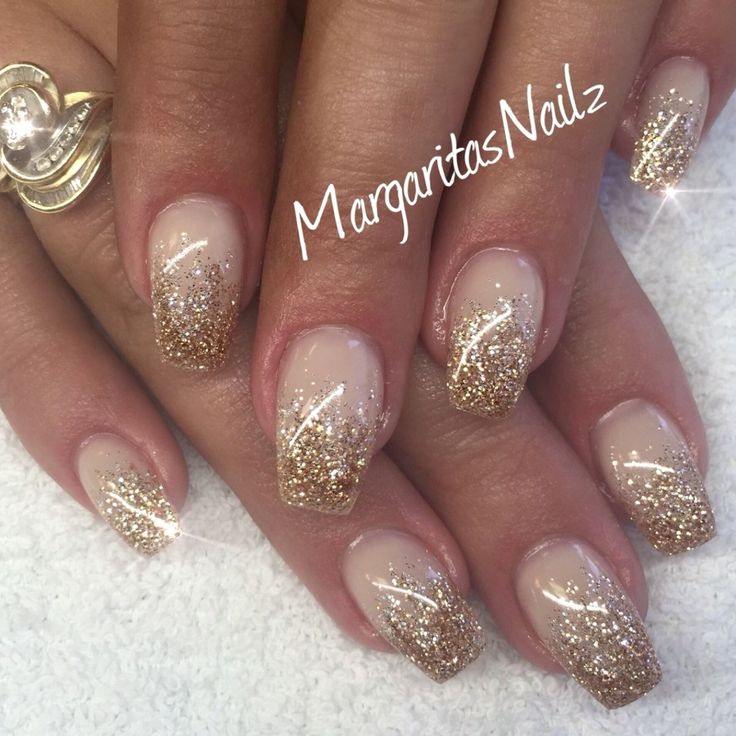 Sophisticated Glitter Ombre Nails: Soft Nude Base with Dazzling Gold Tips and Shimmering Swirls.