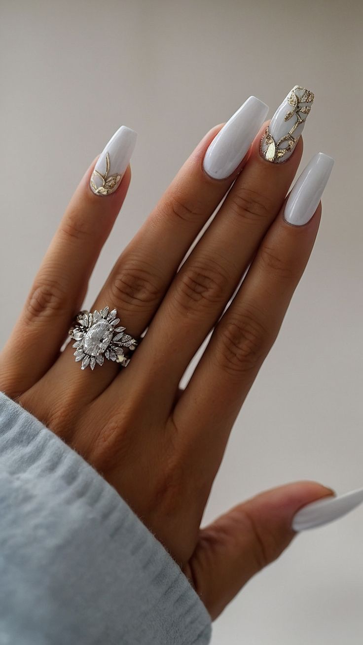 Sophisticated White Nails with Gold Floral Accents and Modern Long Square Shape.