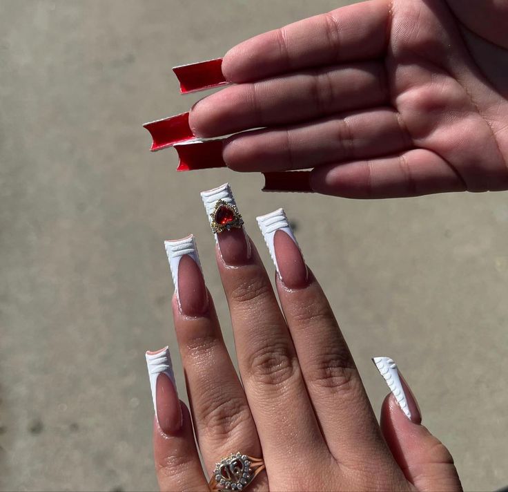 Chic Stiletto Nail Design with Gem Accents and Bold Red Contrast.