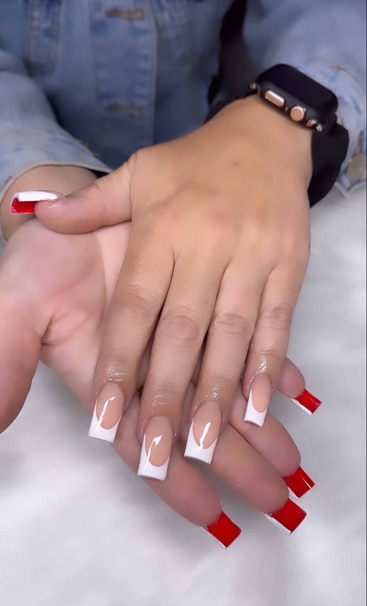 Chic Modern French Nail Design: Classic White Tips with Bold Red Accents and Stylish Negative Space.