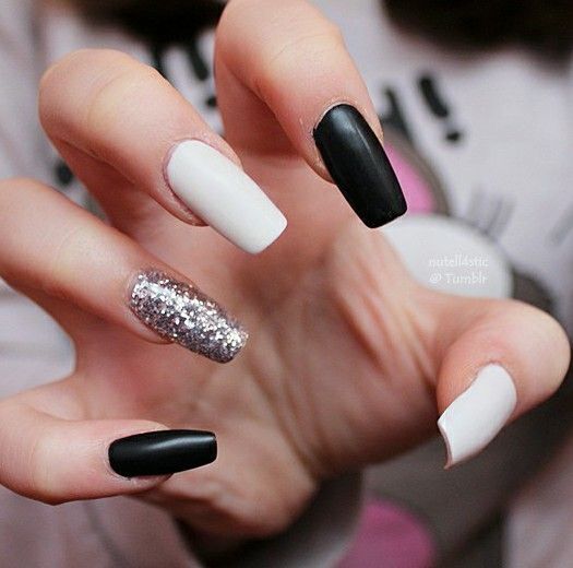 Chic Monochromatic Nail Design with Matte Black, White, and Glamorous Silver Accent.