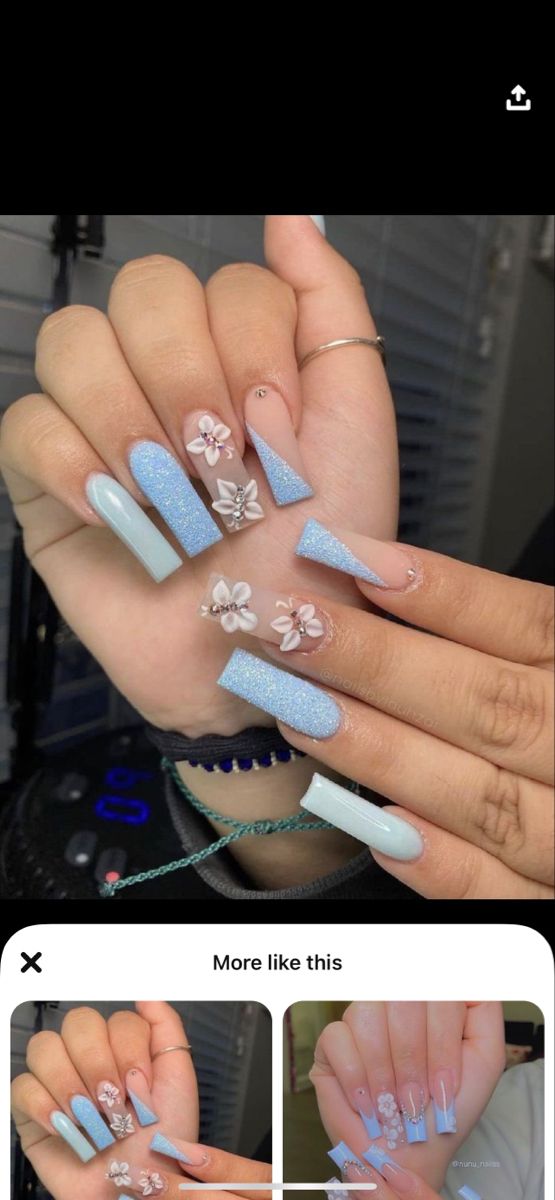 Chic Light Blue Nail Design with Glitter, Floral Accents, and Modern Shapes.