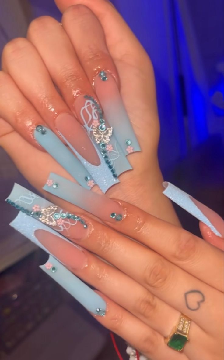 Captivating Nail Design: Elegant Soft Blue Gradient with Lace and Gems.