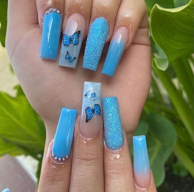 Charming Vibrant Blue Nail Design with Glossy, Glitter Finishes and Butterfly Accents