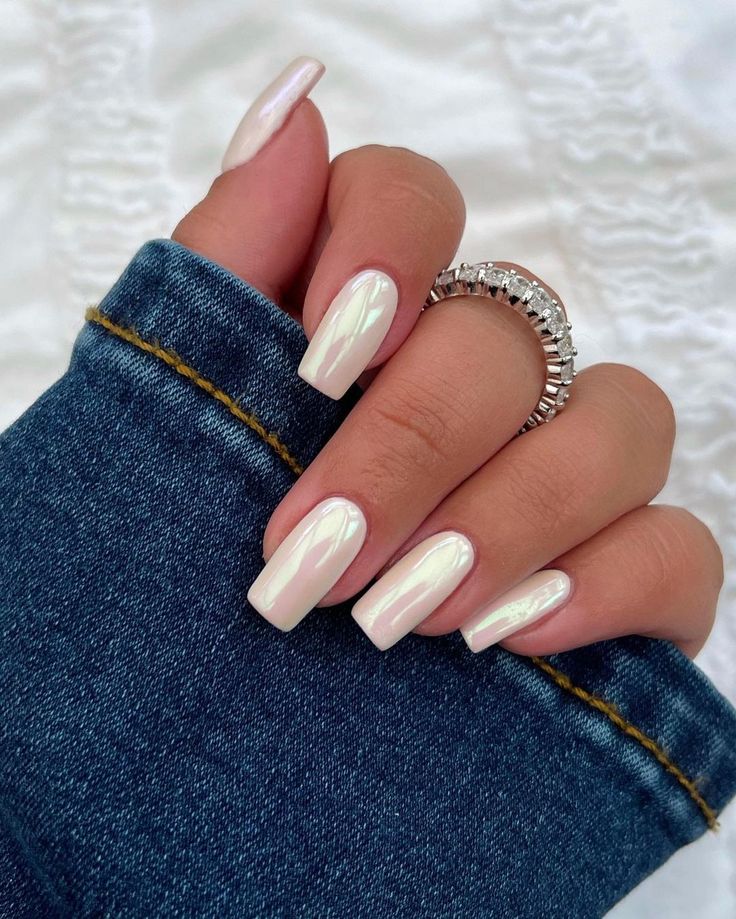 Modern Elegant Nail Design with Glossy Pale Shade and Iridescent Finish.