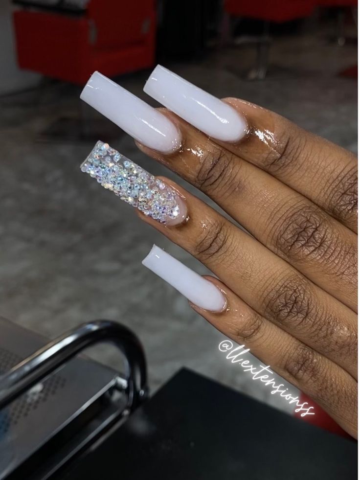 Glamorous Glossy White Long Nails with Sparkling Rhinestone Accent.