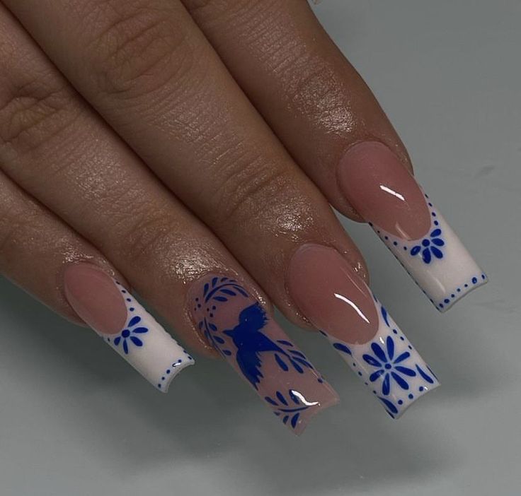 Whimsical Floral Nail Art: Soft Nude and Bright White with Intricate Patterns on Long Square Nails.