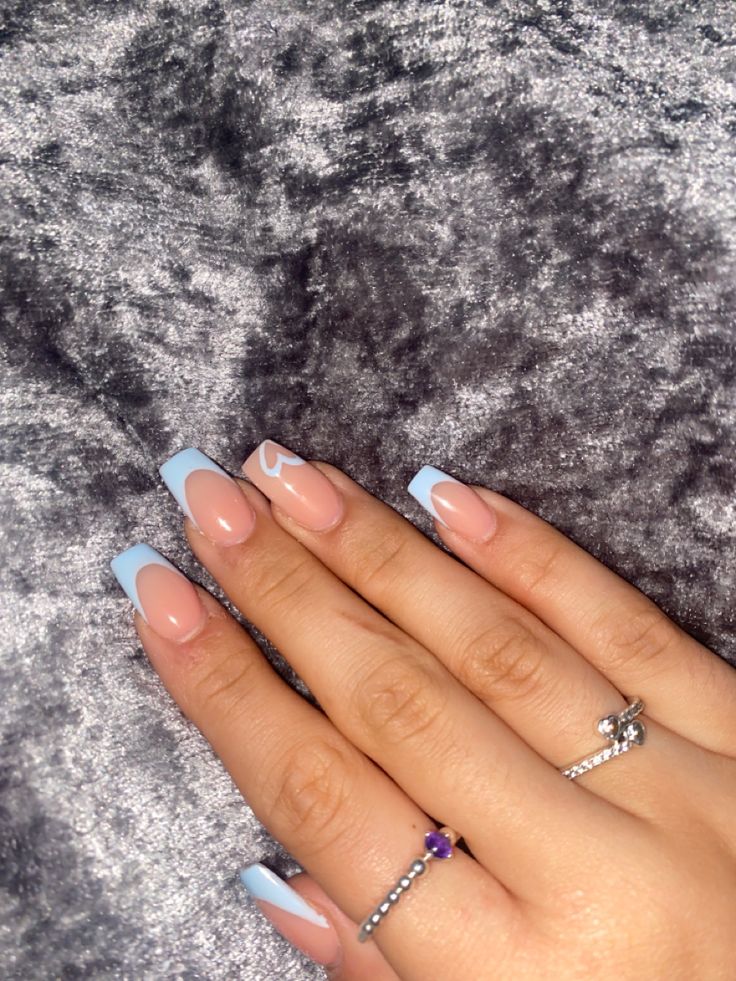 Elegant Blue French Tip Nail Design with Unique Curves and Sophisticated Accents.