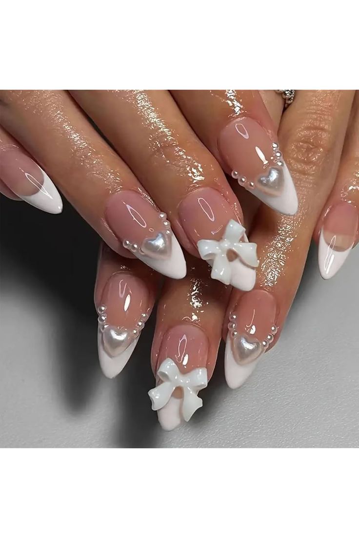 Sophisticated Nail Design with Glossy Nude, Bold White Tips, and 3D Accents.