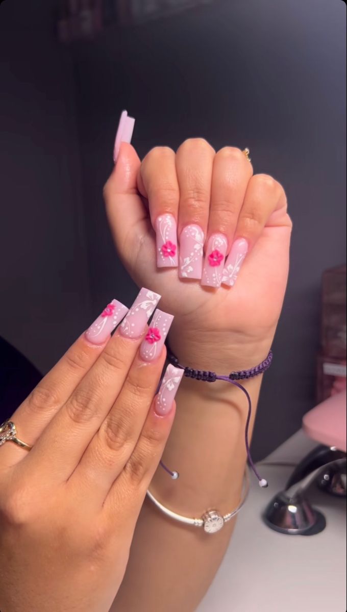 Charming Floral Nail Design with Soft Pink Tones and Vibrant Accents