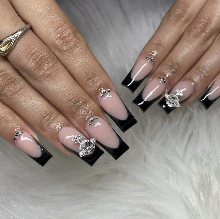 Sophisticated French Tip Nail Design with Glossy Black Contrast and Glamorous Accents.