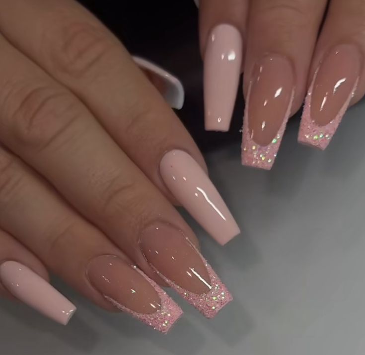 Elegant Stiletto Nail Design: Soft Pink and Nude with Glamorous Glitter Tips