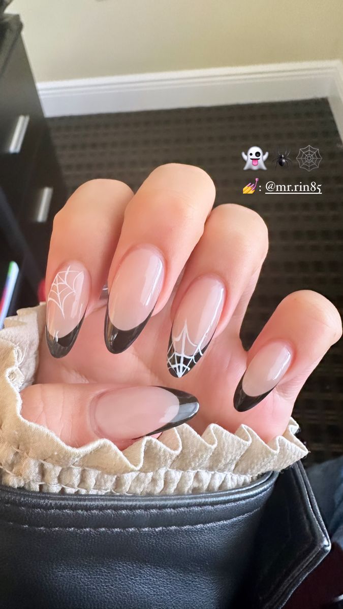 Chic Nail Design with Nude and Black Tones Featuring Intricate Spider Web Patterns for a Playful, Seasonal Elegance.