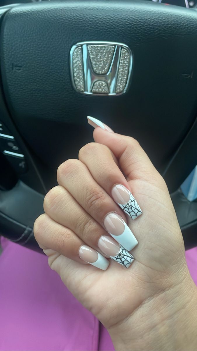 Chic Nail Art: Nude and White Tips with Intricate Spider Web Accent for a Playful Touch.