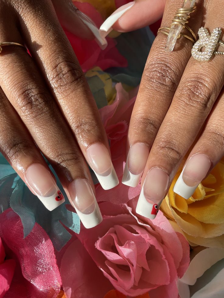 Chic French Tip Nails with Glossy White Design and Subtle Cherry Embellishments.