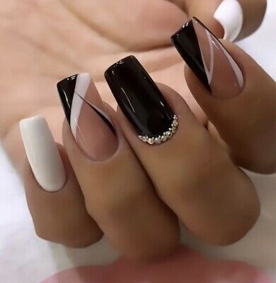 Chic Nail Design: Bold Black, Nude, and White with Geometric Patterns and Rhinestones.