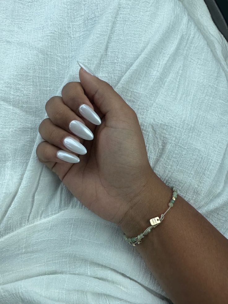 Sophisticated Almond-Shaped Nails with Pearlescent Finish and Understated Elegance