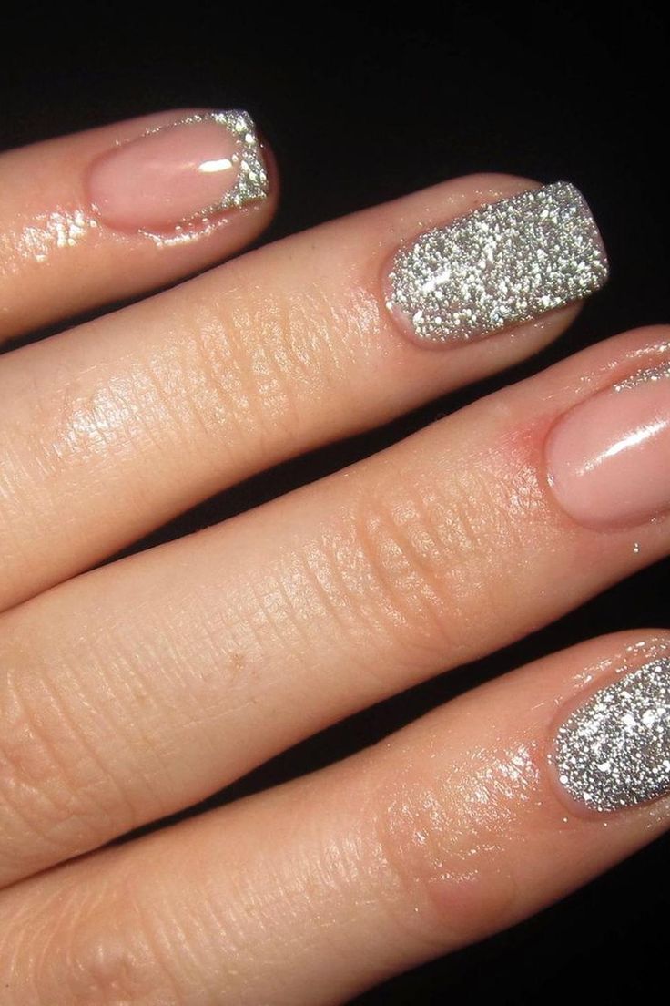 Elegant Glittering Nail Design: Sophisticated Nude Base with Glamorous Silver Accents.