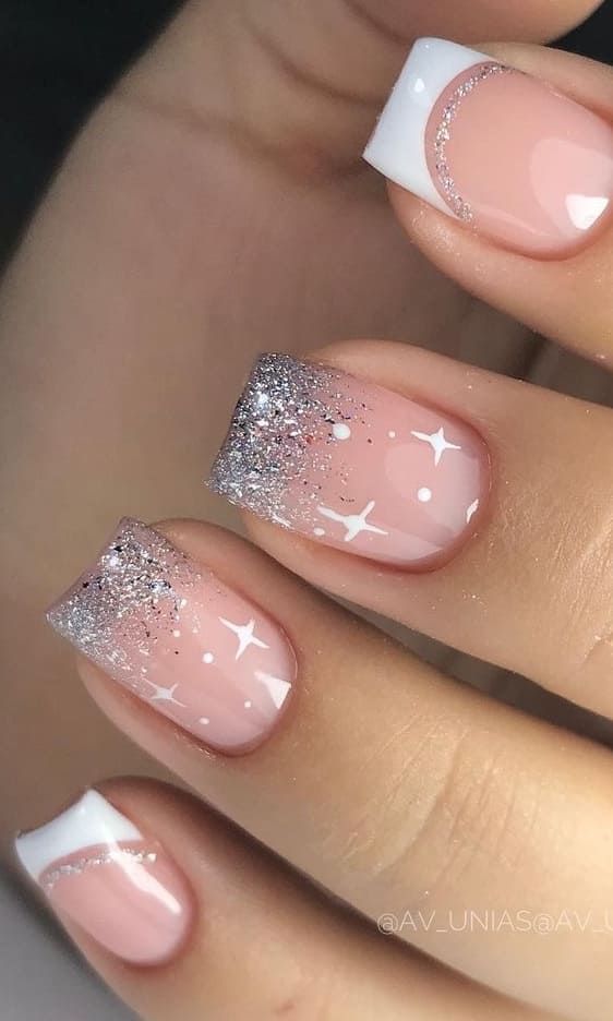 Elegant Sparkly French Tip Nails: Soft Pink Base with Glittery Silver Tips and Delicate White Stars for a Chic Look.