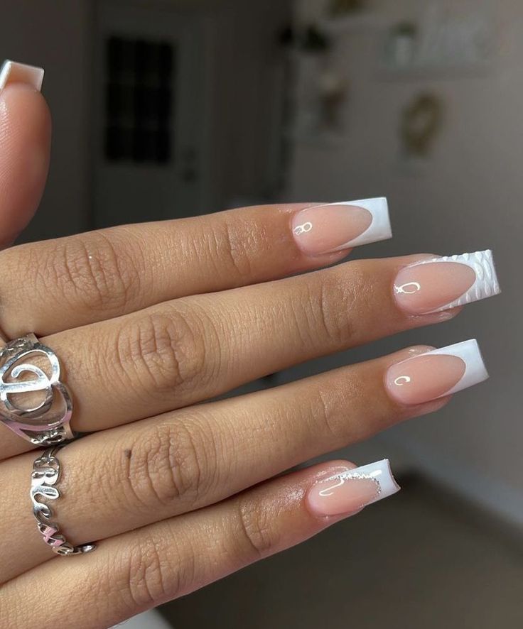 Elegant Nude Base with Sophisticated White French Tips: A Timeless Manicure.