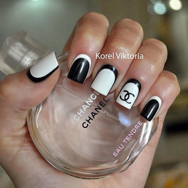 Chic Monochromatic Nail Design with Elegant Geometric Patterns and Bold Logo Accent.