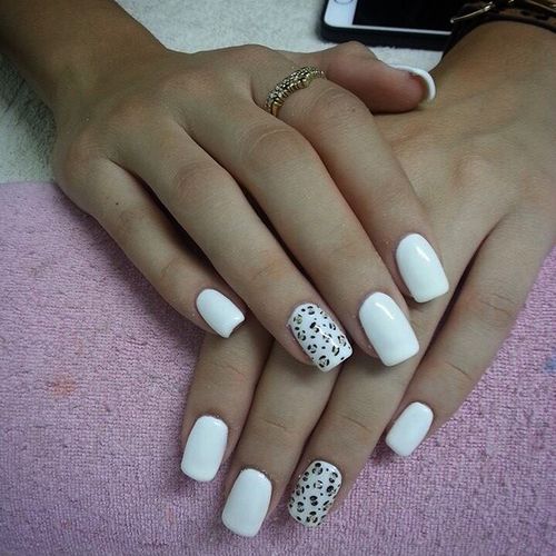 Chic White Manicure with Bold Black and White Leopard Accent Nail