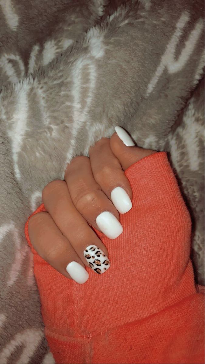 Stylish White Nail Design with Bold Leopard Print Accent.