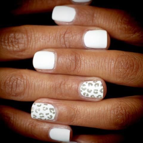 Chic White Nail Design with Leopard Print Accent for Playful Elegance.