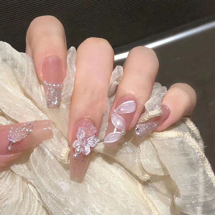 Whimsical Sophistication: Elegant Pink Nail Design with 3D Embellishments and Glitter Accents.