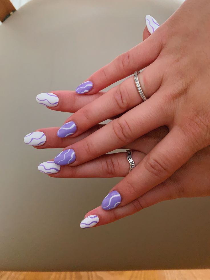 Elegant Lavender Nail Art with Playful Abstract Patterns.