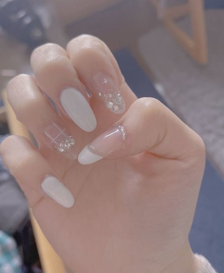 Sophisticated Elegant Nail Design with White and Clear Elements and Delicate Embellishments.