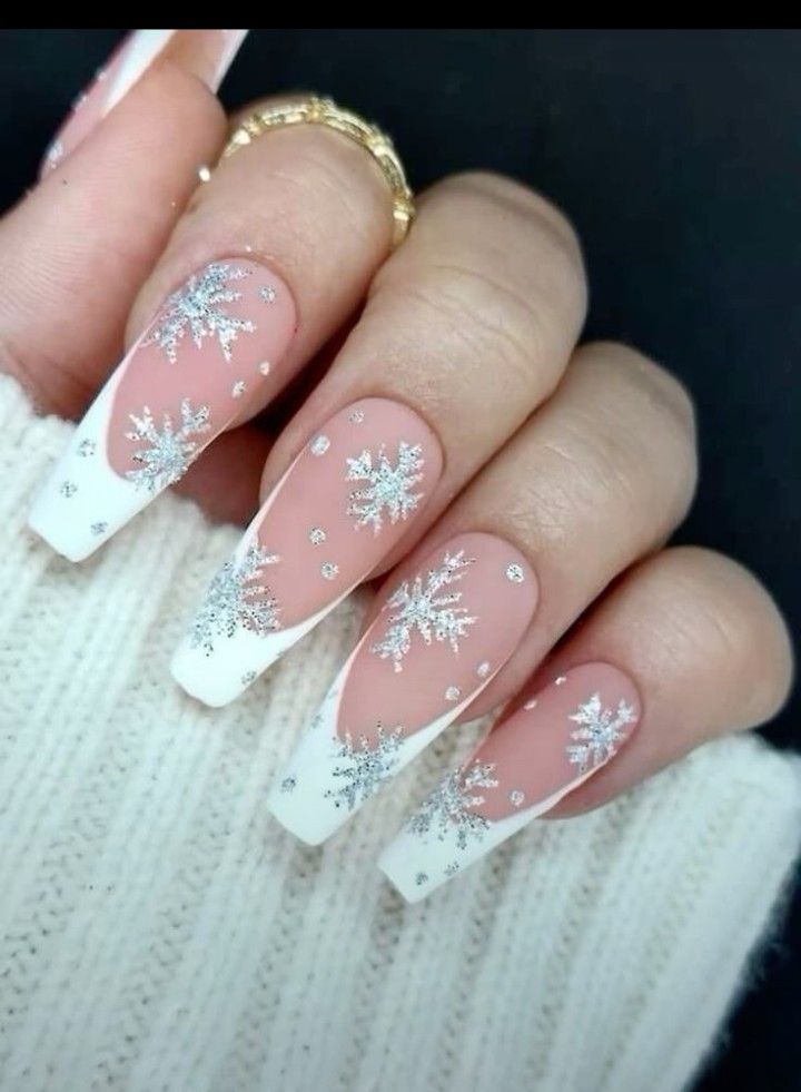 Elegant Winter Nail Design: White Tips, Nude Base, and Silver Snowflakes with Sparkling Rhinestones.