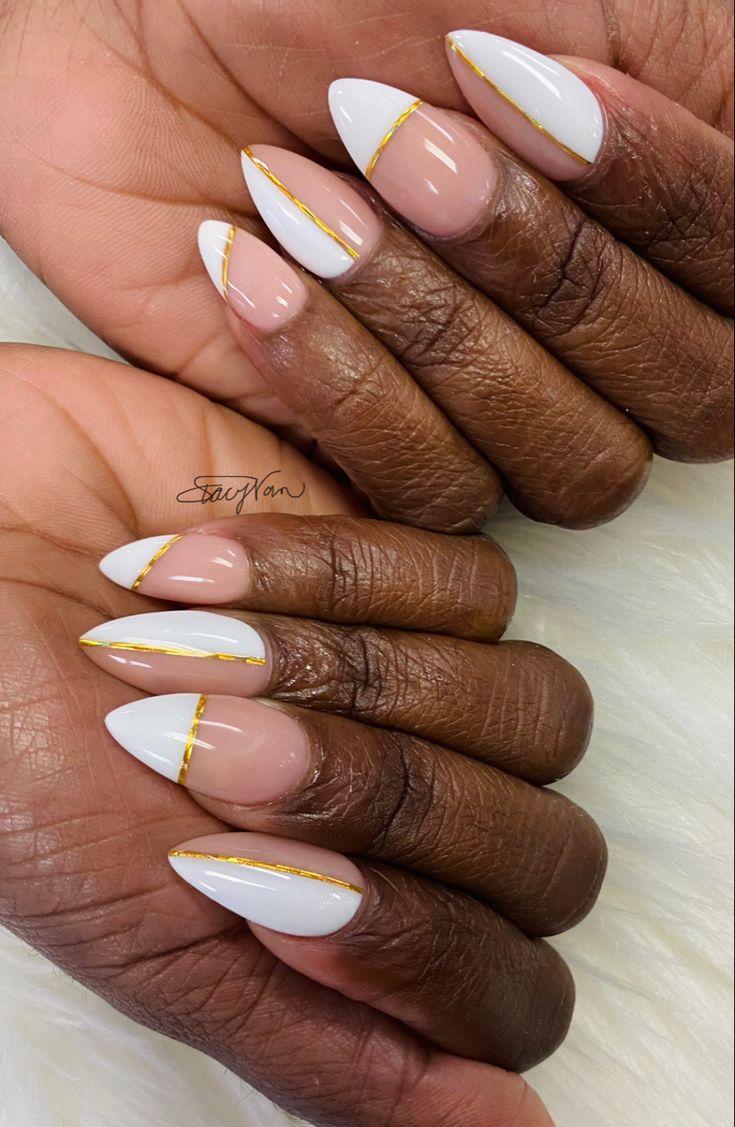 Chic Almond-Shaped Nail Design with Glossy White Polish and Golden Accents