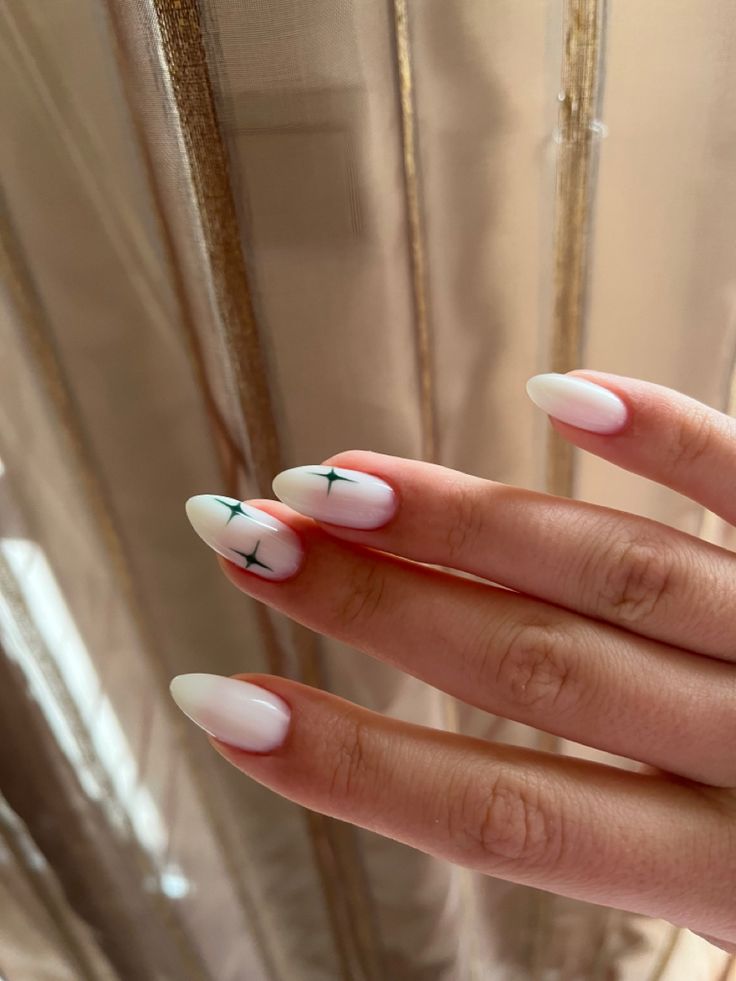 Sophisticated Almond-Shaped Ombre Nails with Geometric Dark Green Designs.